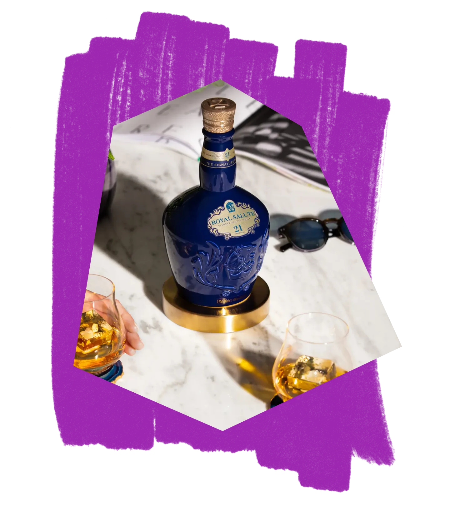 A bottle of Royal Salute and glasses on a marble tabletop, against a purple textured background.
